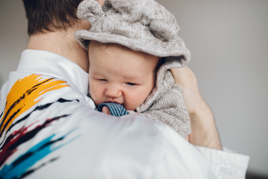 Neugeborenenfotos Berlin Familienreportage Berlin-Wedding: Vater hält Baby auf dem Arm