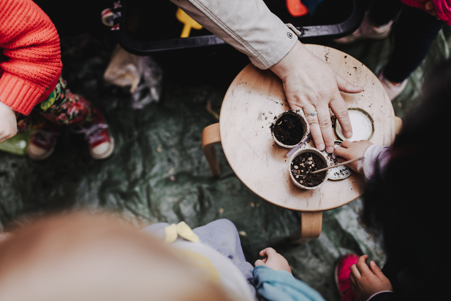 Familienreportage Berlin: Kinder setzen Pflanzensetzlinge in Erde